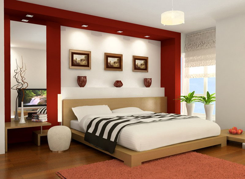 A bedroom with a bed and red walls

Description automatically generated